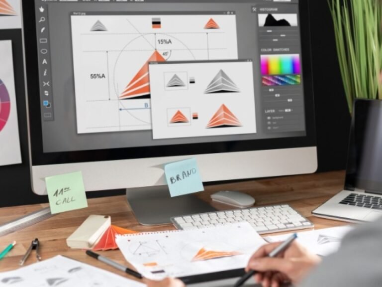 Graphic designer working on artwork on a desktop computer