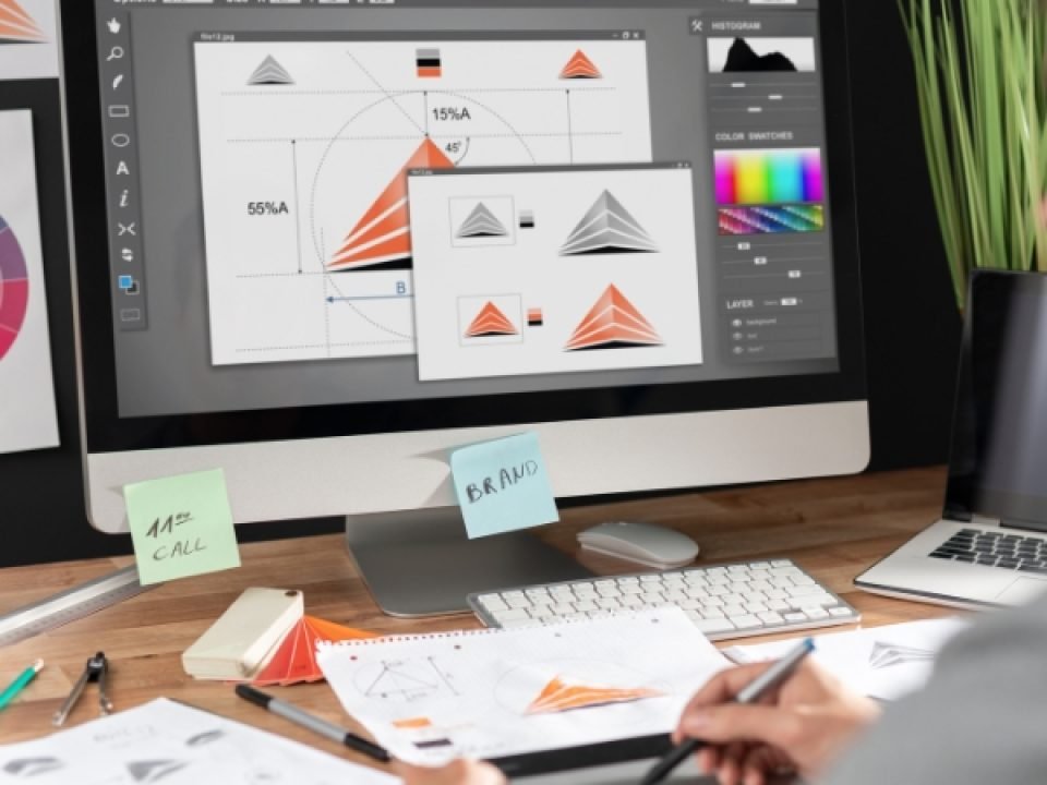 Graphic designer working on artwork on a desktop computer
